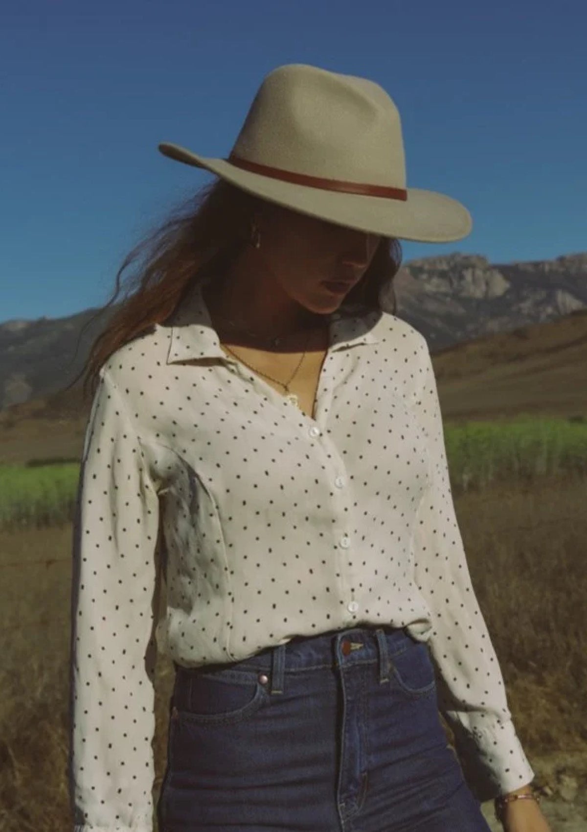 Paired with blouse tucked in high rise dark blue jeans.
