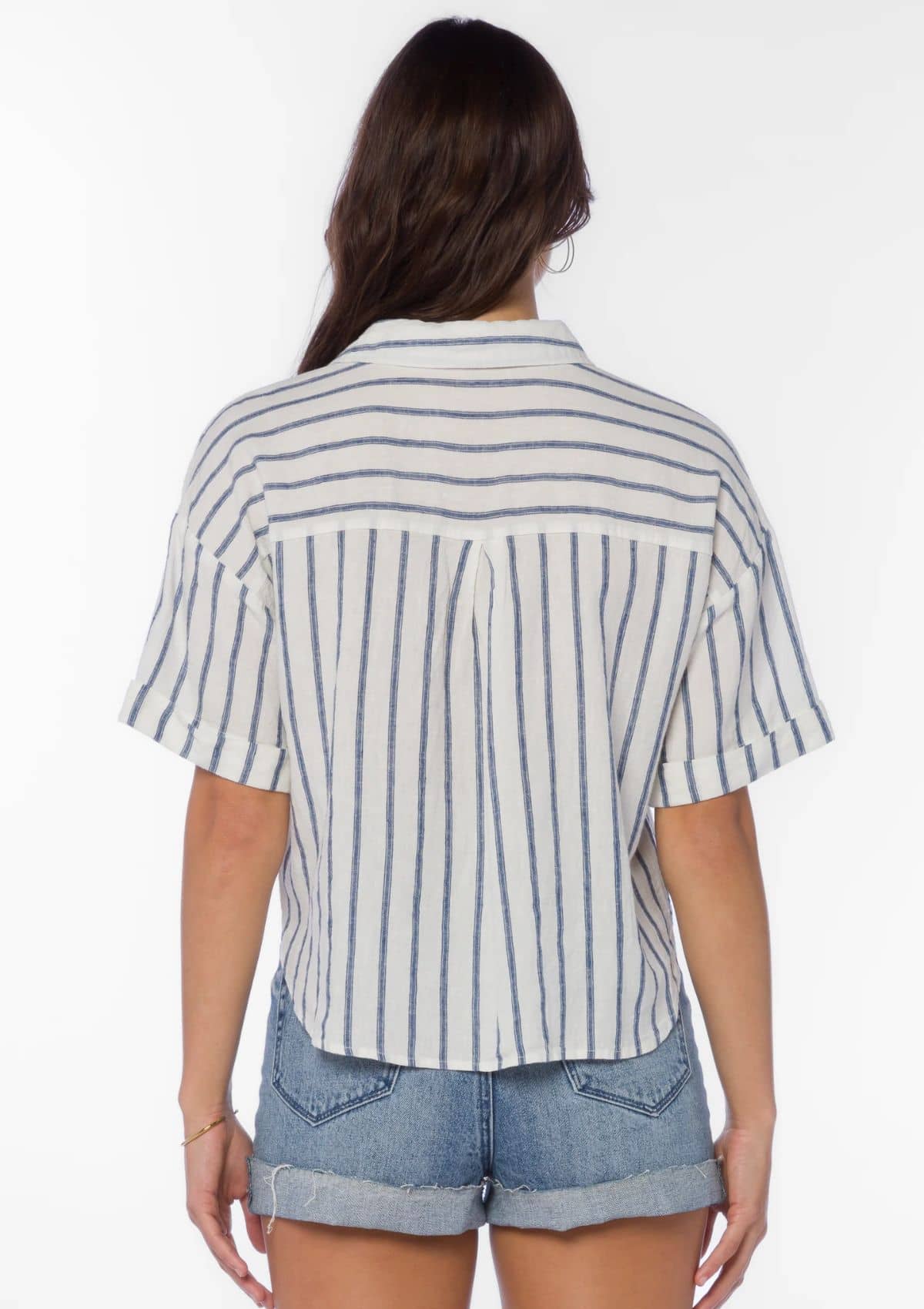 White with thin blue stripes. Paired with jean shorts.