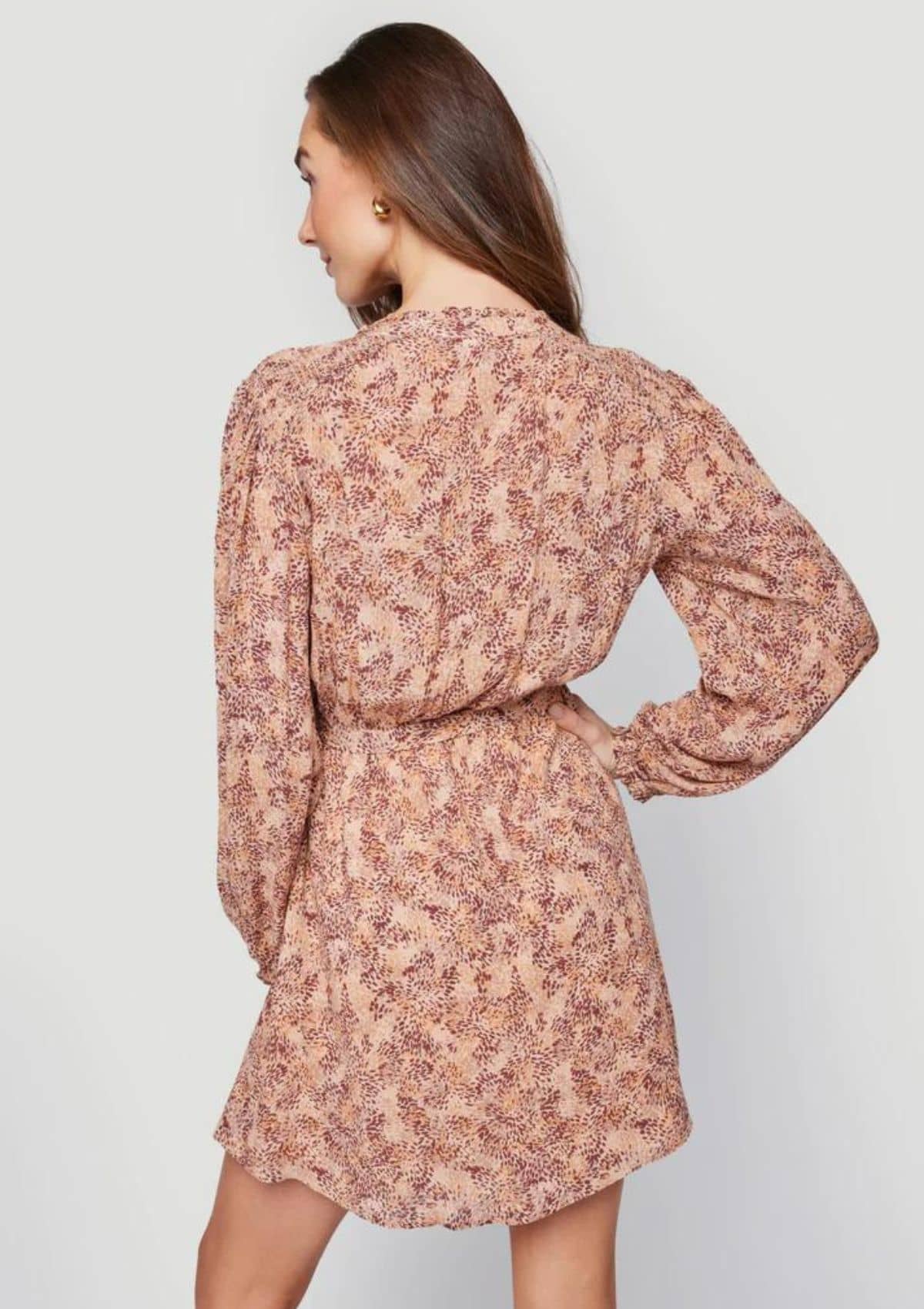 Mini long sleeve with floral patterns paired with gold jewelry.