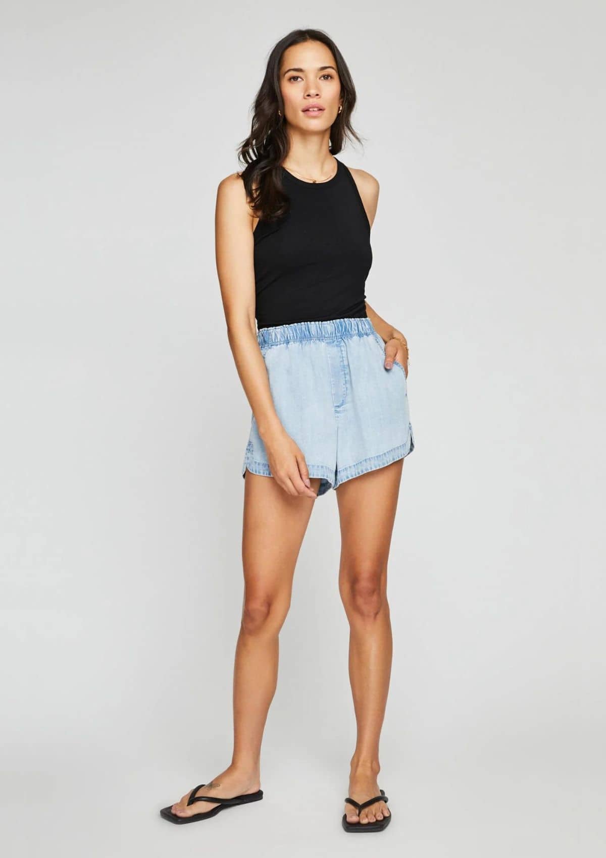 Tucked in high rise jean shorts.