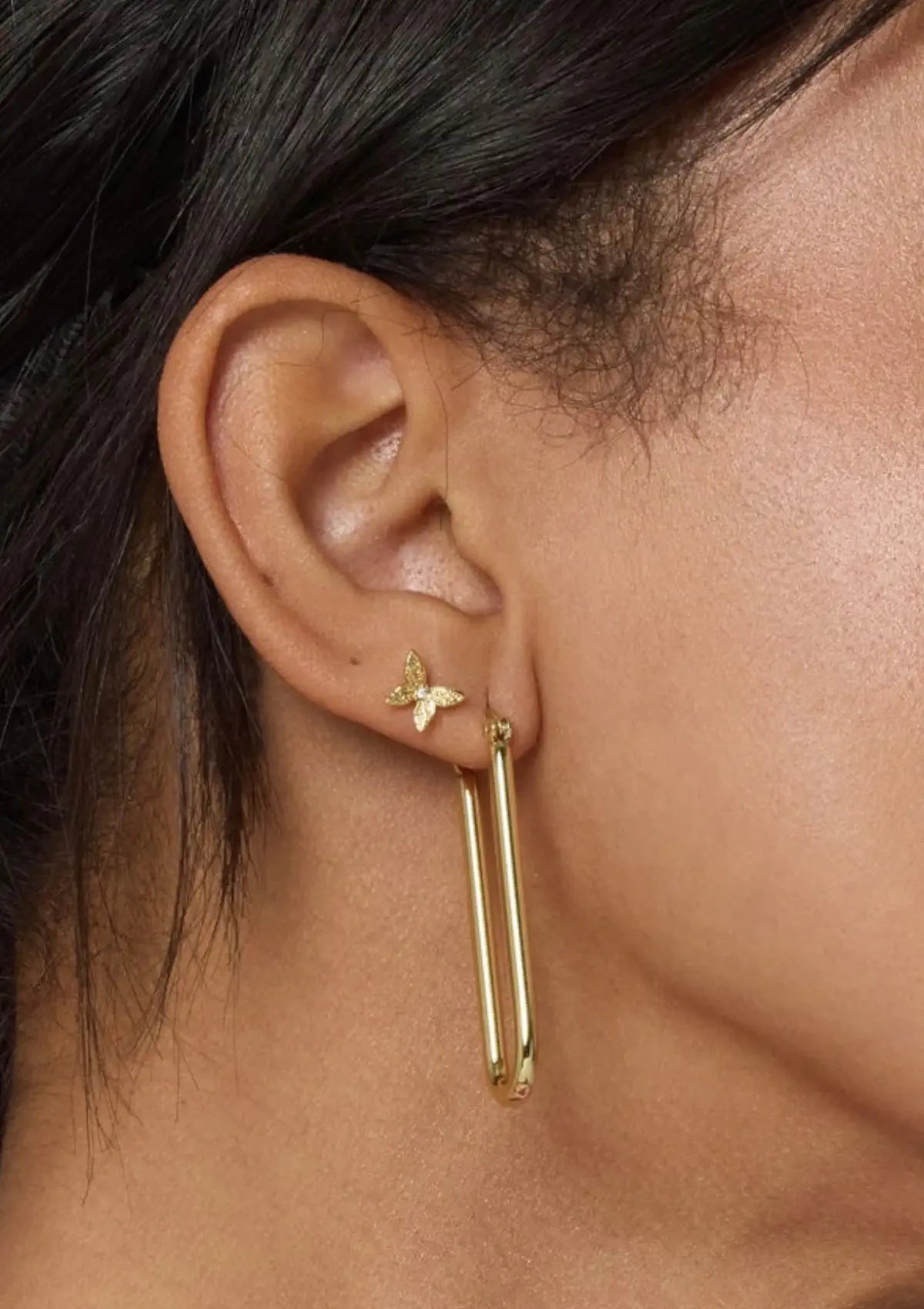 Long round rectangle shape paired with gold butterfly stud earrings.