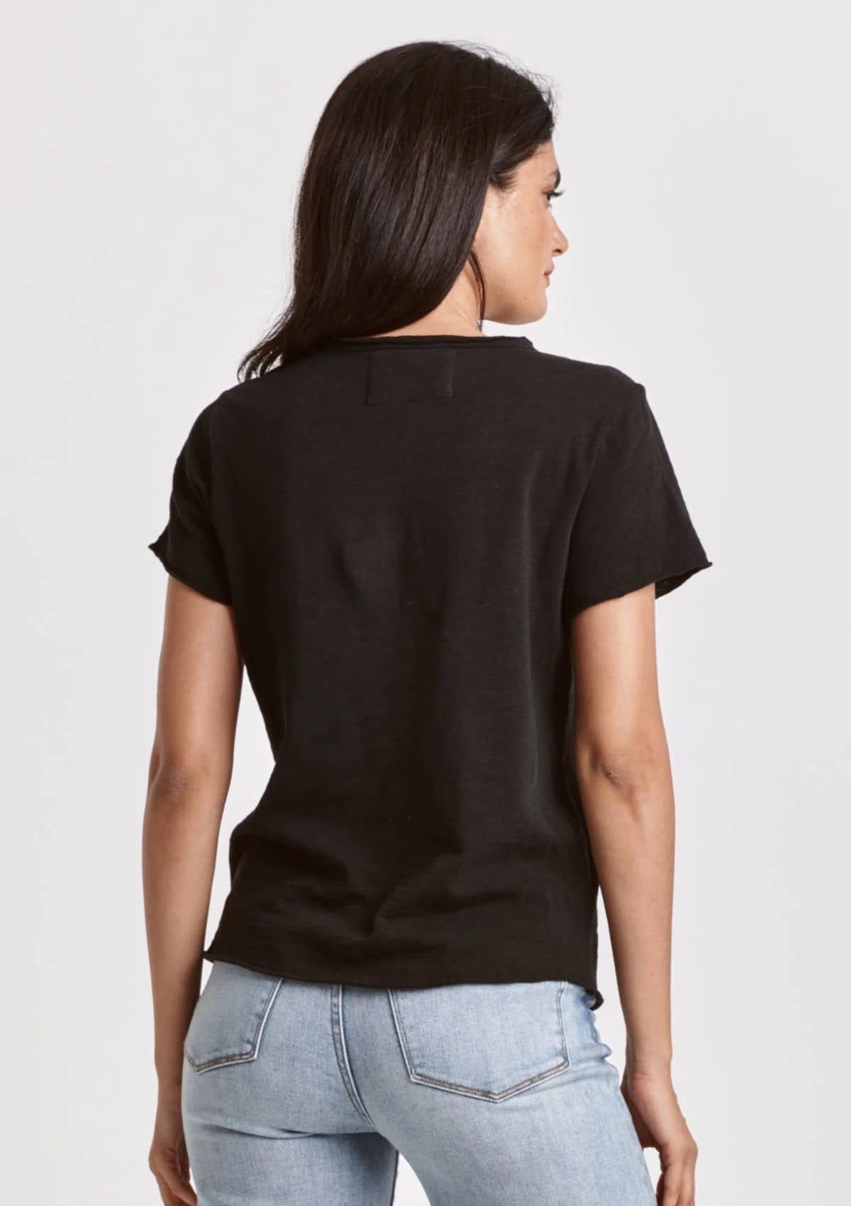 Basic black tee paired with white washed jeans.