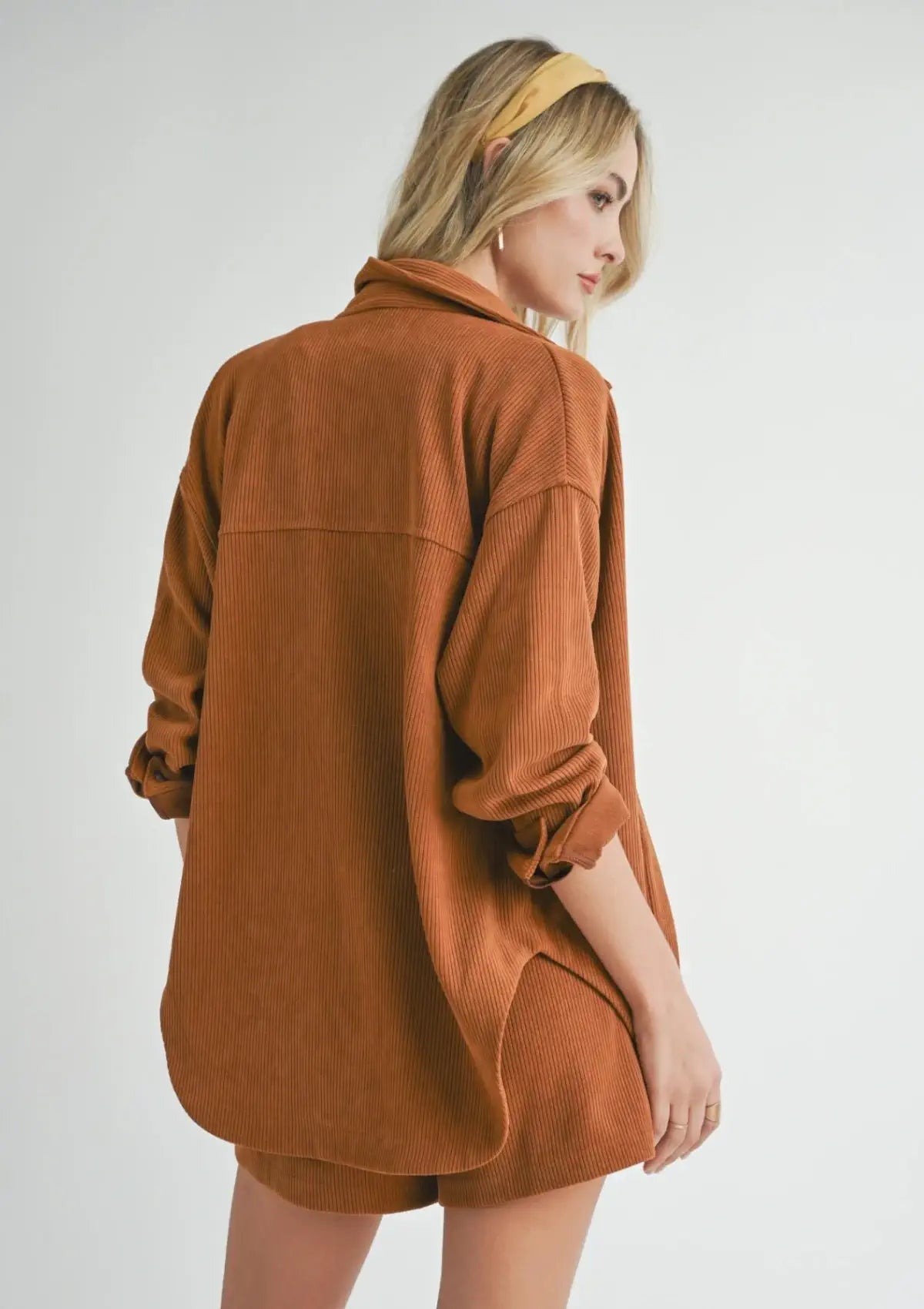 Curve hem, collar, roll tab sleeves. Paired with yellow headband, brown boots, and silver jewelry.