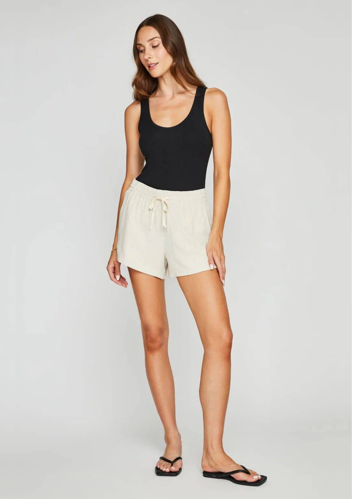 Deep scoop neck. Paired with white shorts.