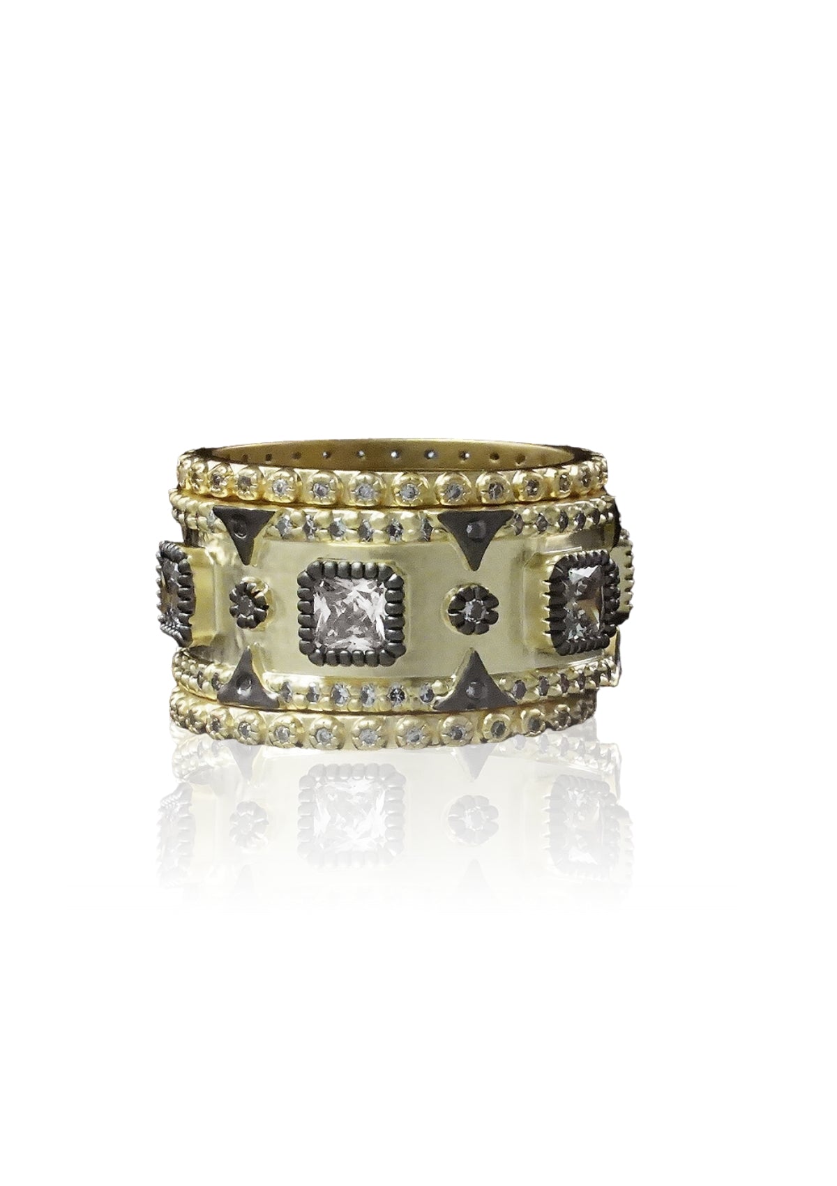 Gold stackable rings with square stones and black accents.