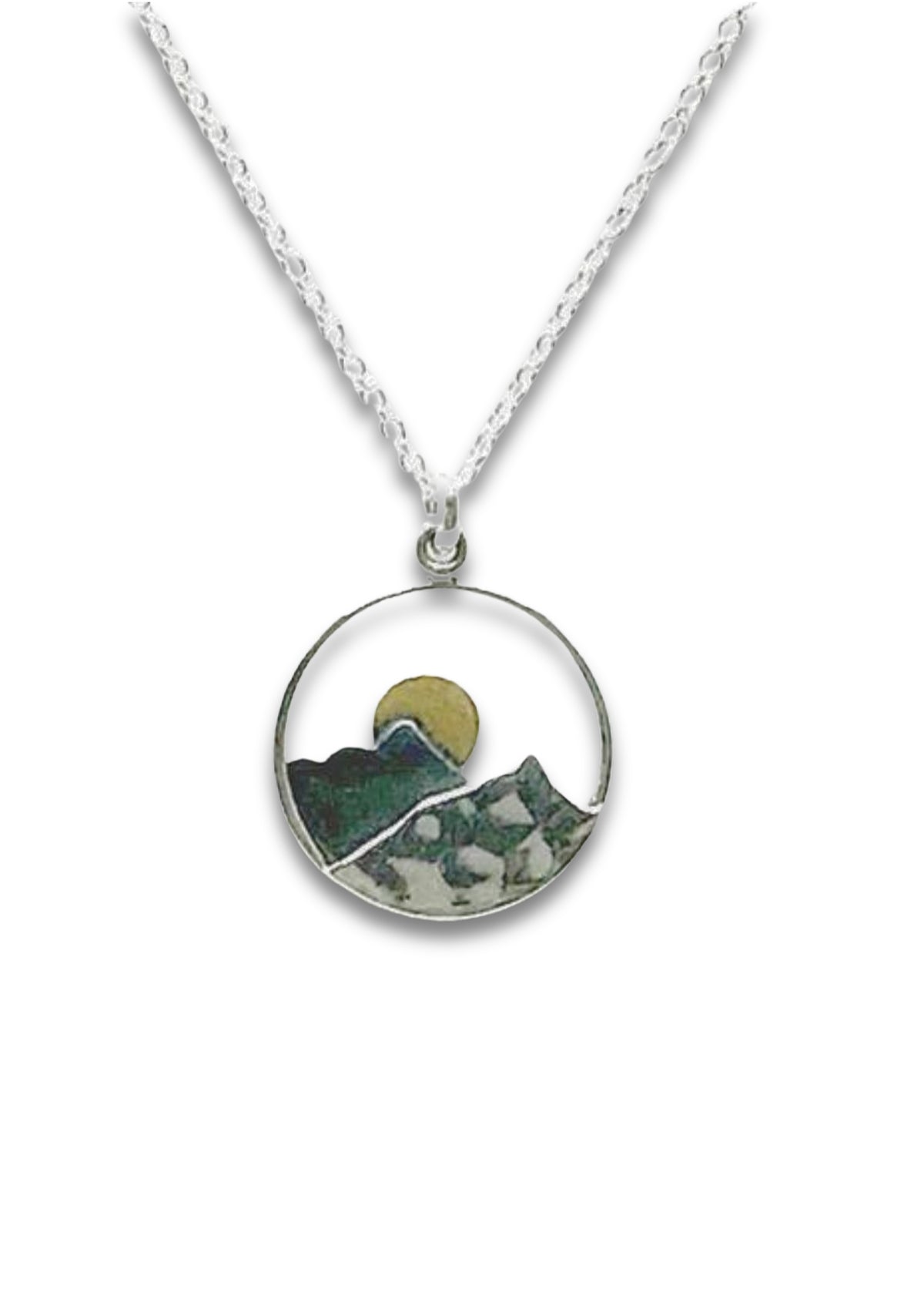 round thin silver with yellow moon layered behind dark mountain with lighter mountain in front. Silver chain.