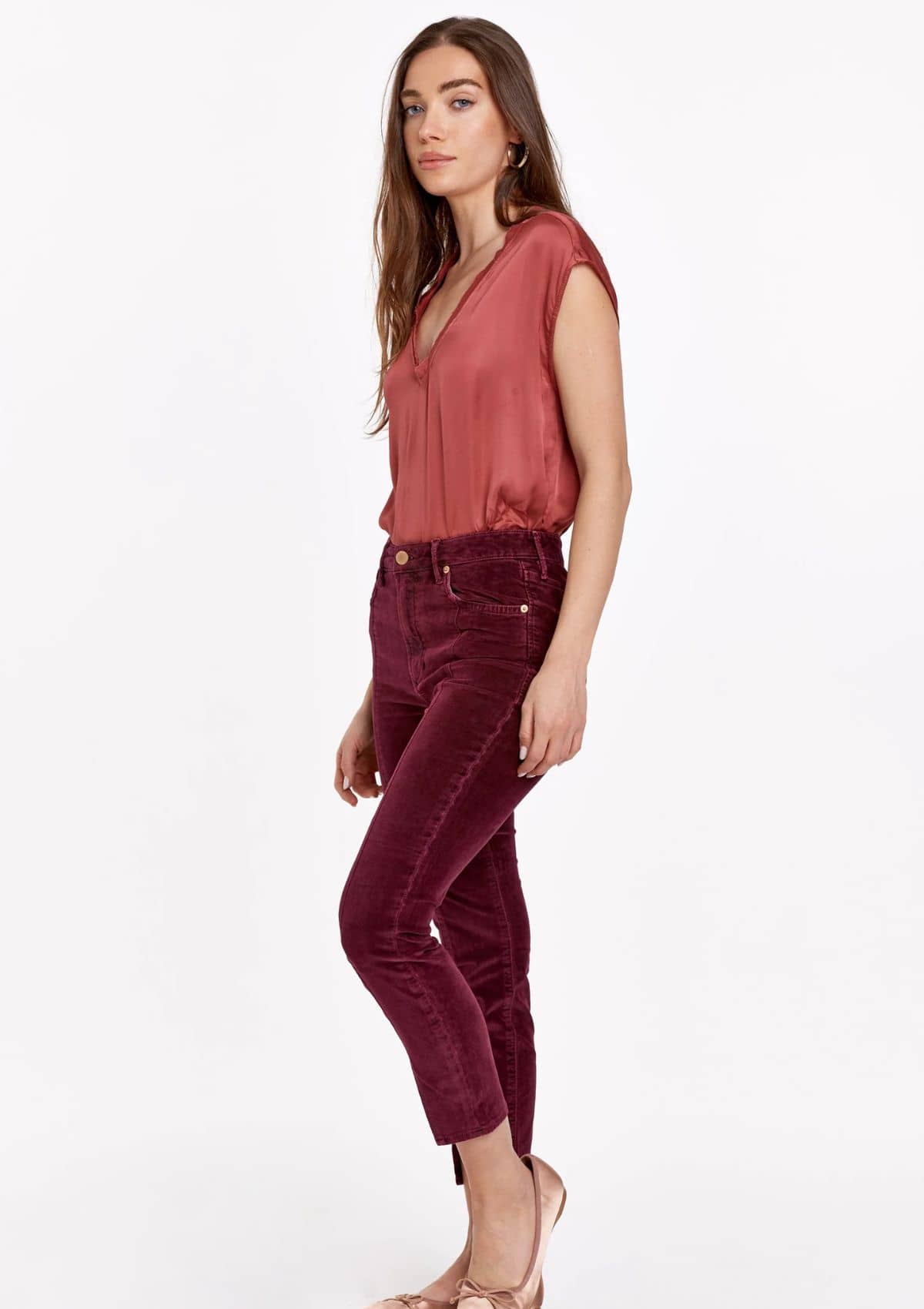 Mid-calf length red jeans paired with tucked in red cami top.