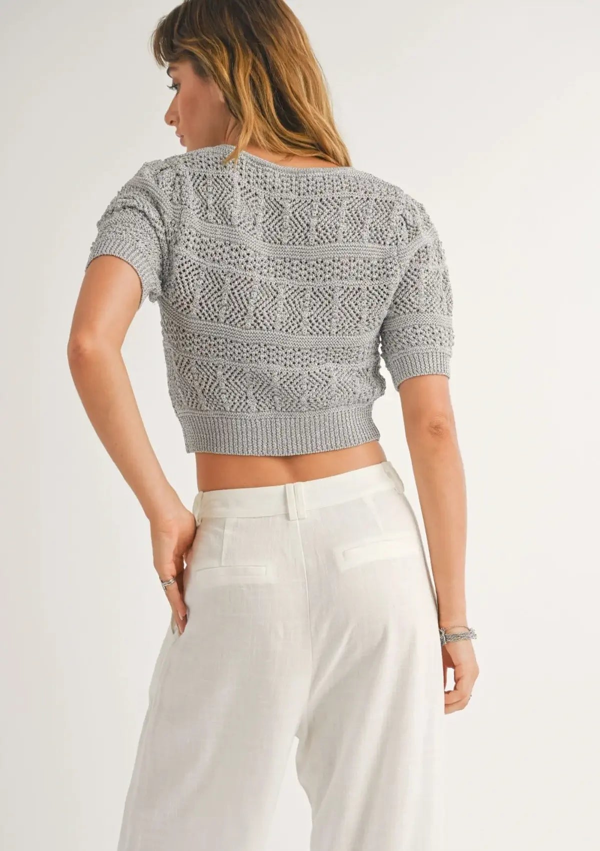 Grey knit. Paired with high rise white pleated slacks.