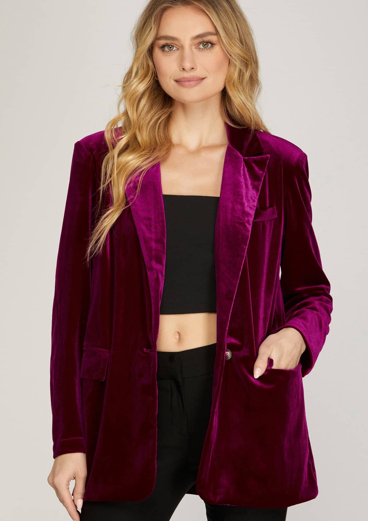 Purple velvet blazer paired with black cami top and black pants.