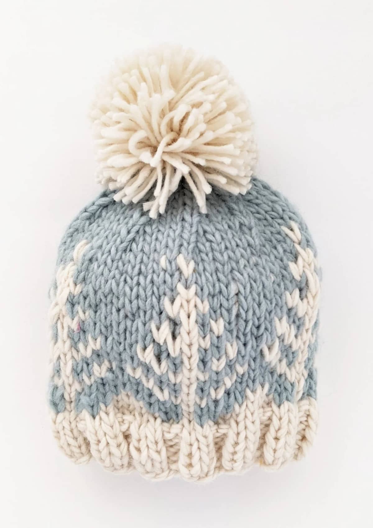 Blue white baby teen beanie with trees in knit and white pom pom.